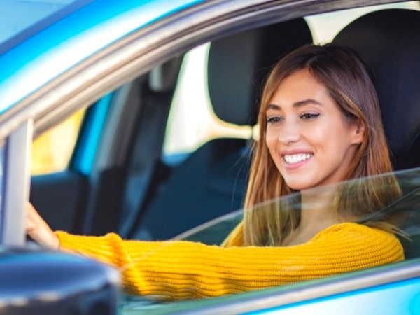 Woman Driving a Blue Car