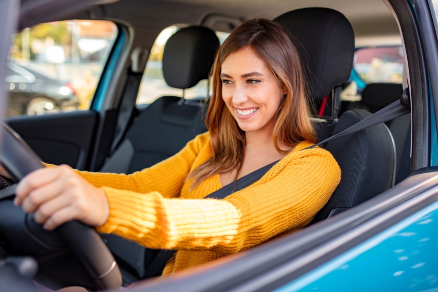 Woman Driving a Blue Car