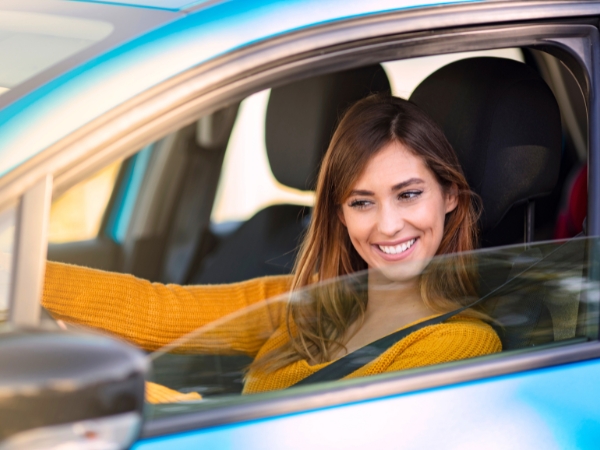 Woman Driving a Blue Car